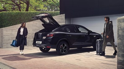 one man and one woman sitting in the backseats of the renault arkana