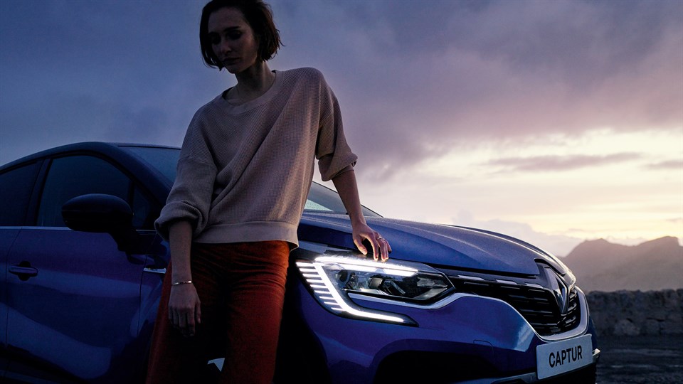 a woman is sitting in the front right side of the Renault Captur