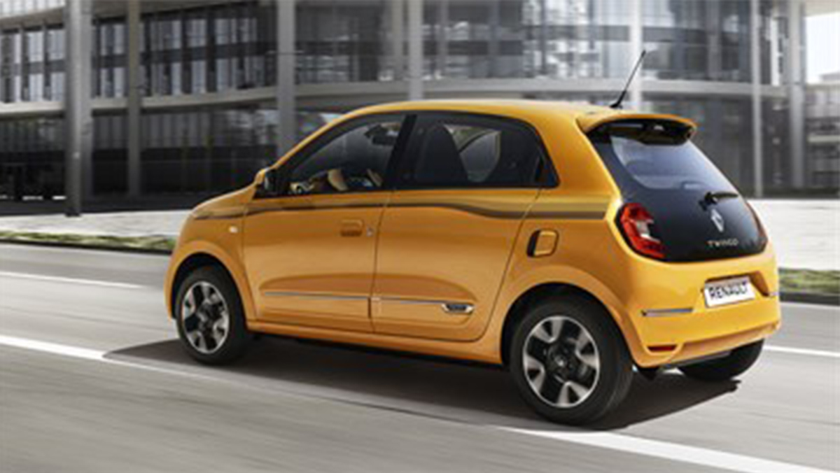 a yellow reanult twingo on the road driving